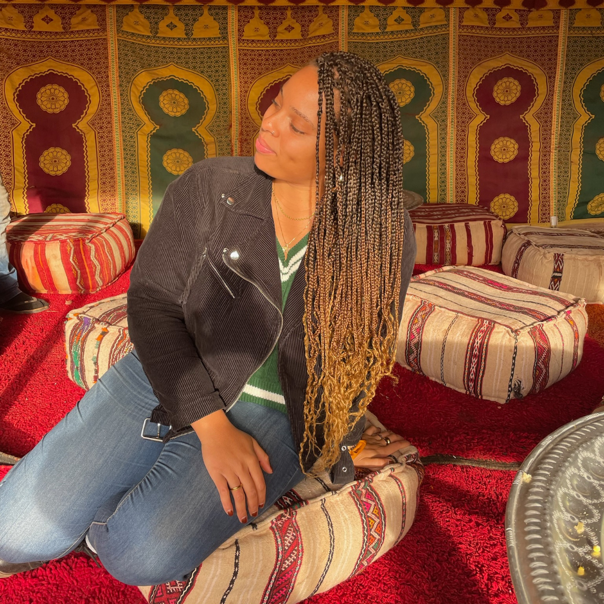 Joy Poses on Pouf in Moroccan Tent, Photo Credit: Joy Grant