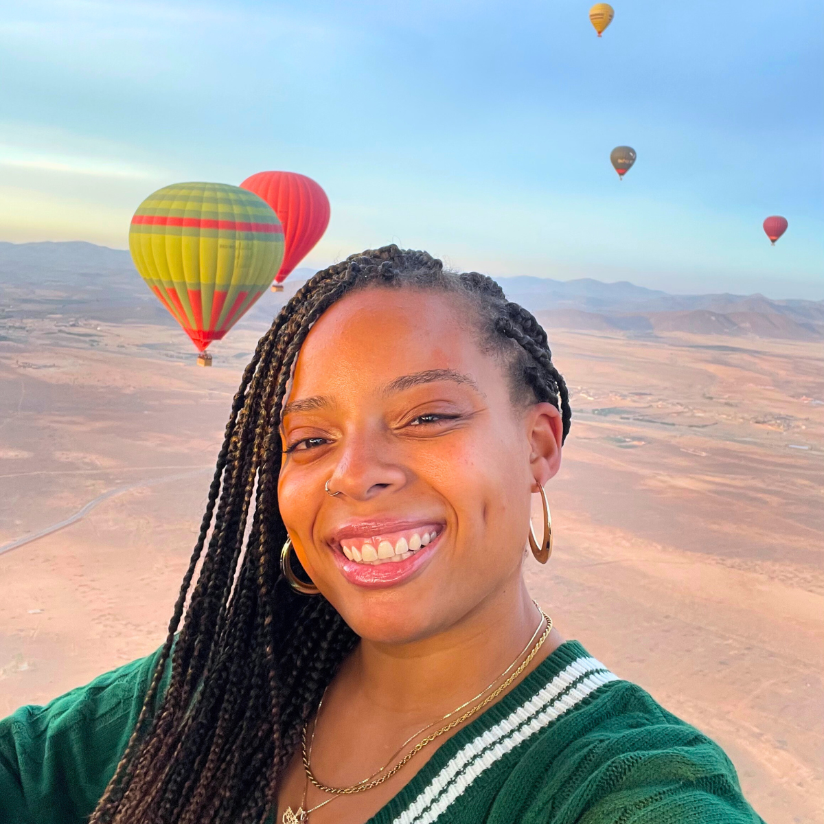 Joy Smiles with Hot Air Balloons in the Background