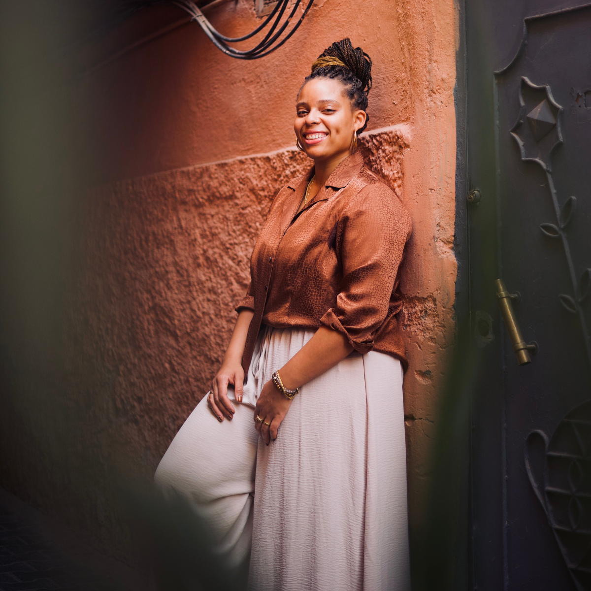 Joy Smiles While Leaning Against a Wall in the Medina