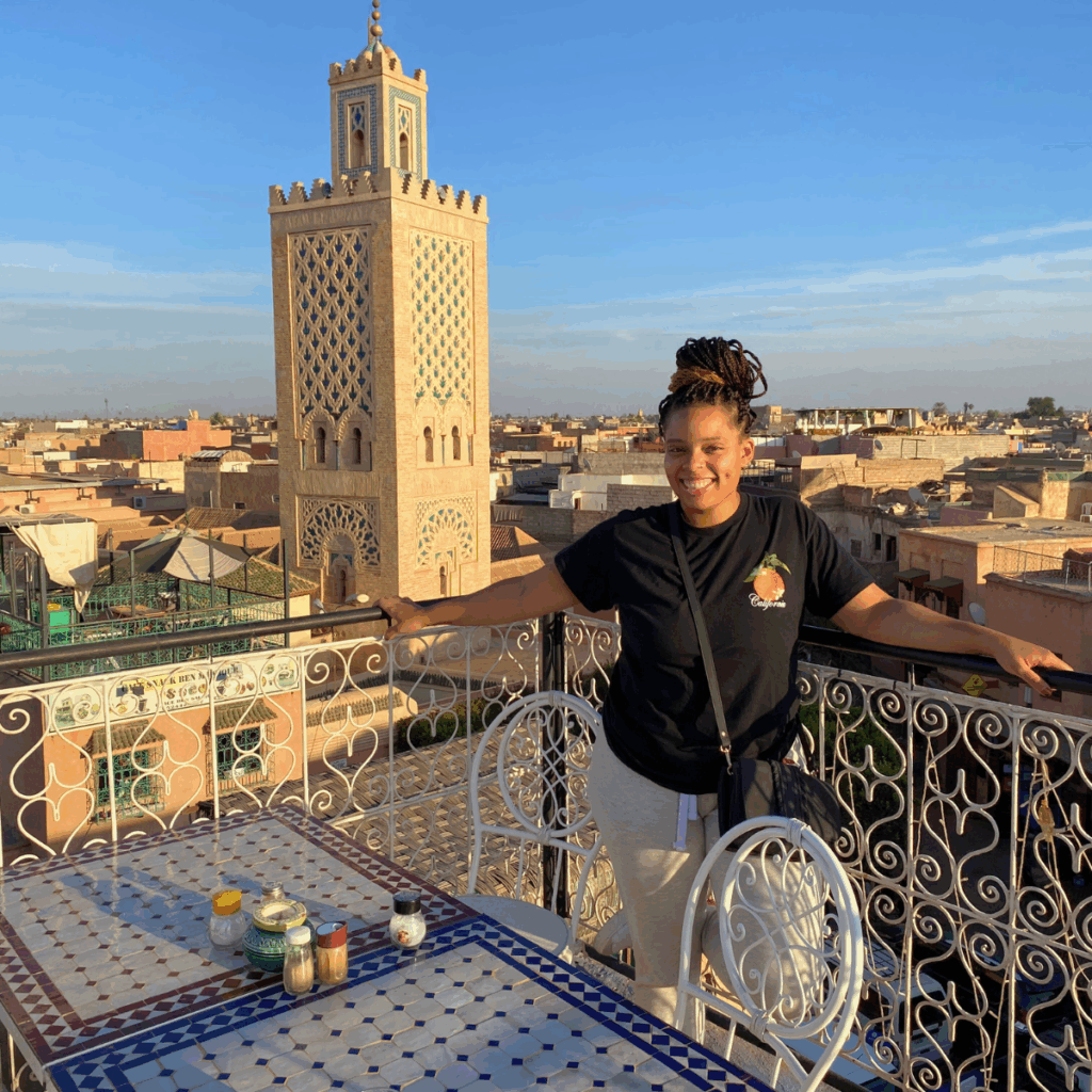 Joy posed on a rooftop with the Ben Youssef Mosque in the background